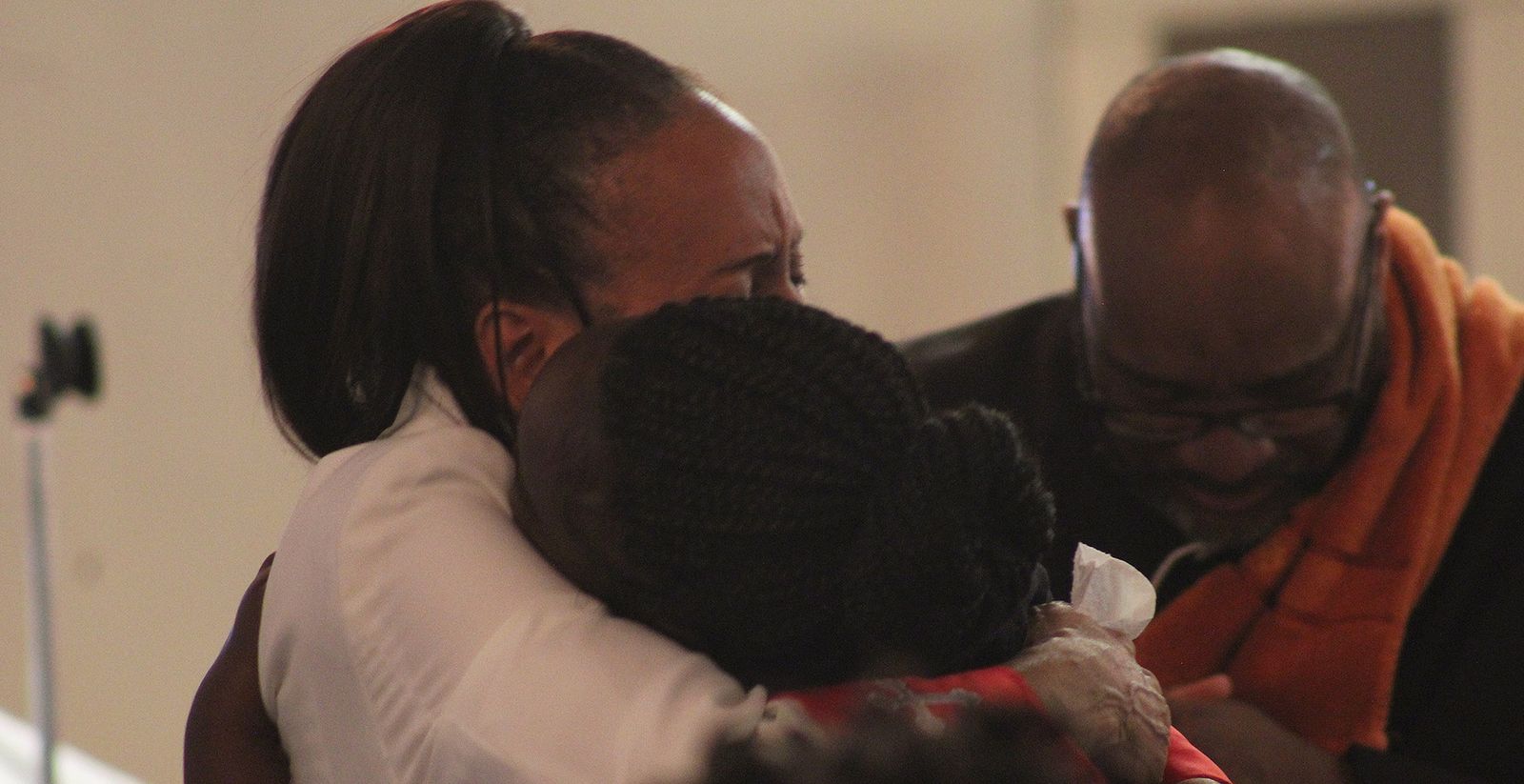 Two members of the congregation embracing during worship